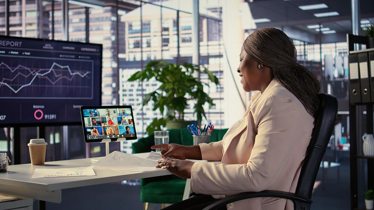 Analyst reviewing cost dashboards at her desk