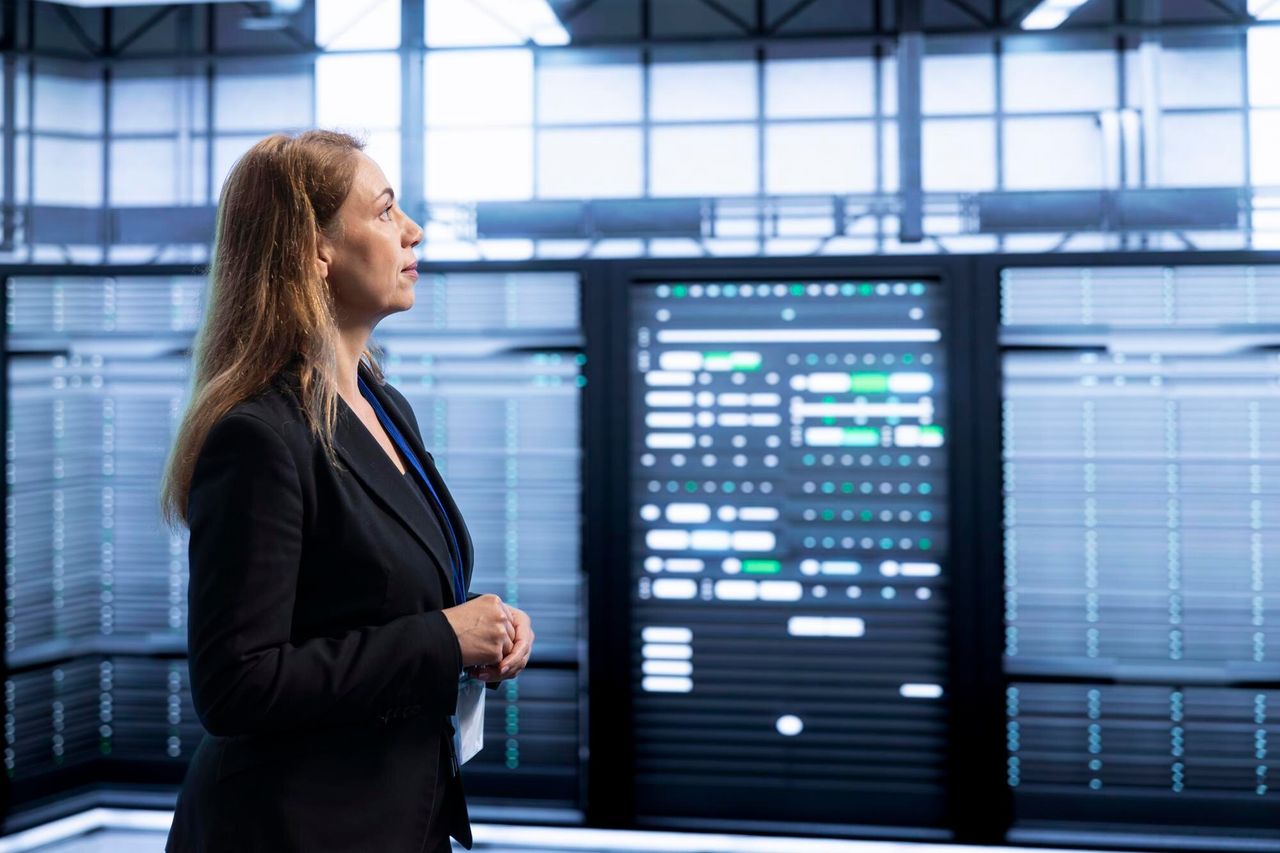 Engineer at a monitoring console in a data center