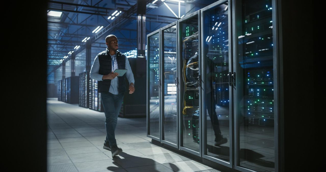 Engineer walking a data center aisle