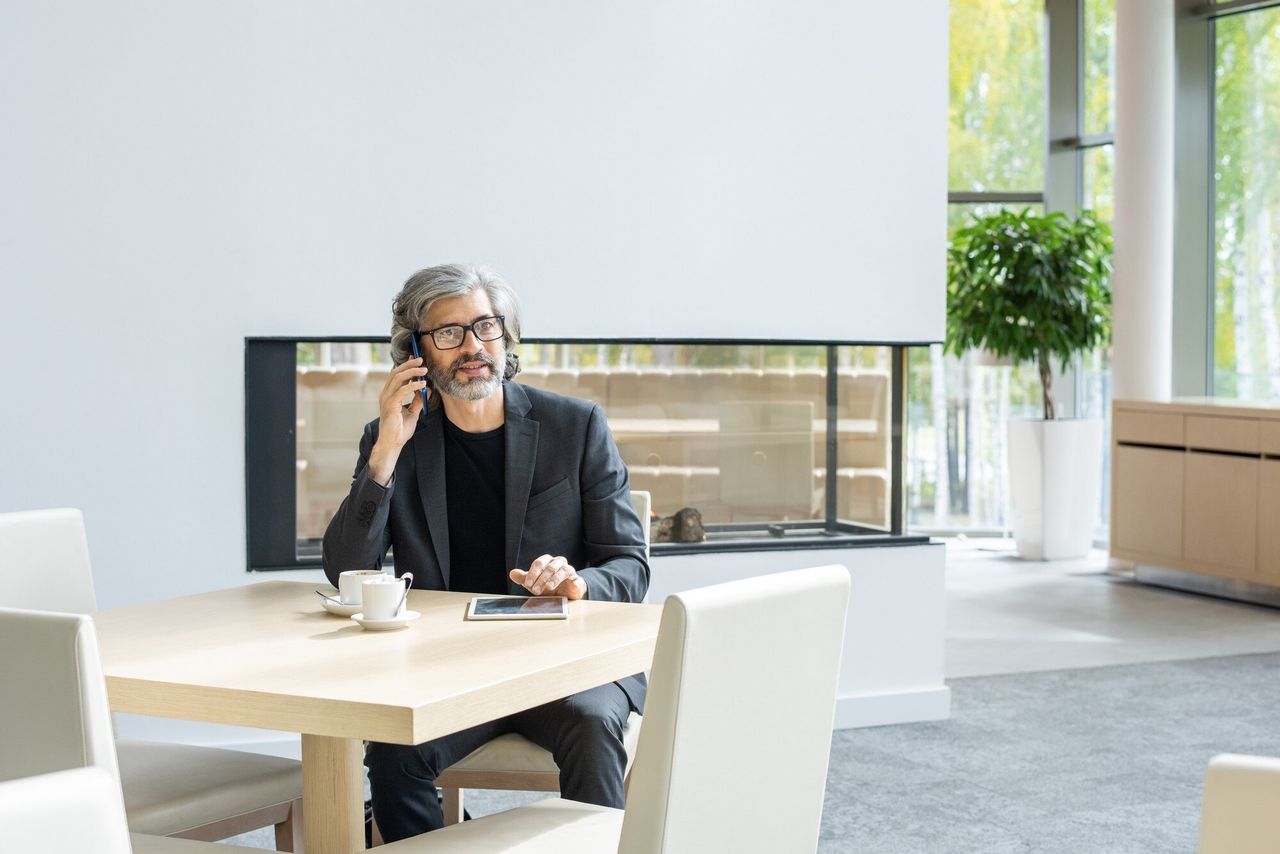 Professional on a call at a bright office table