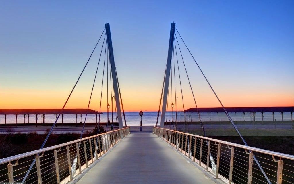 A cable-stayed pedestrian bridge at Revere Beach at dusk