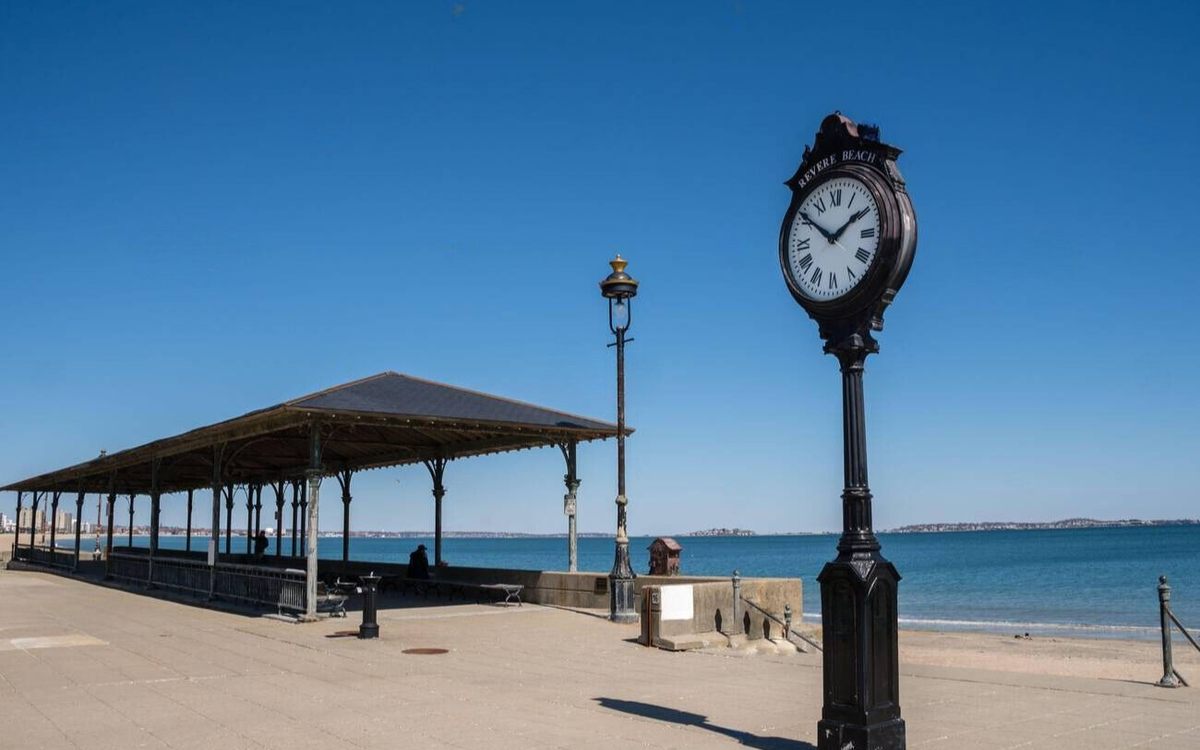 The pavilion and street clock on the Revere Beach promenade on a clear day